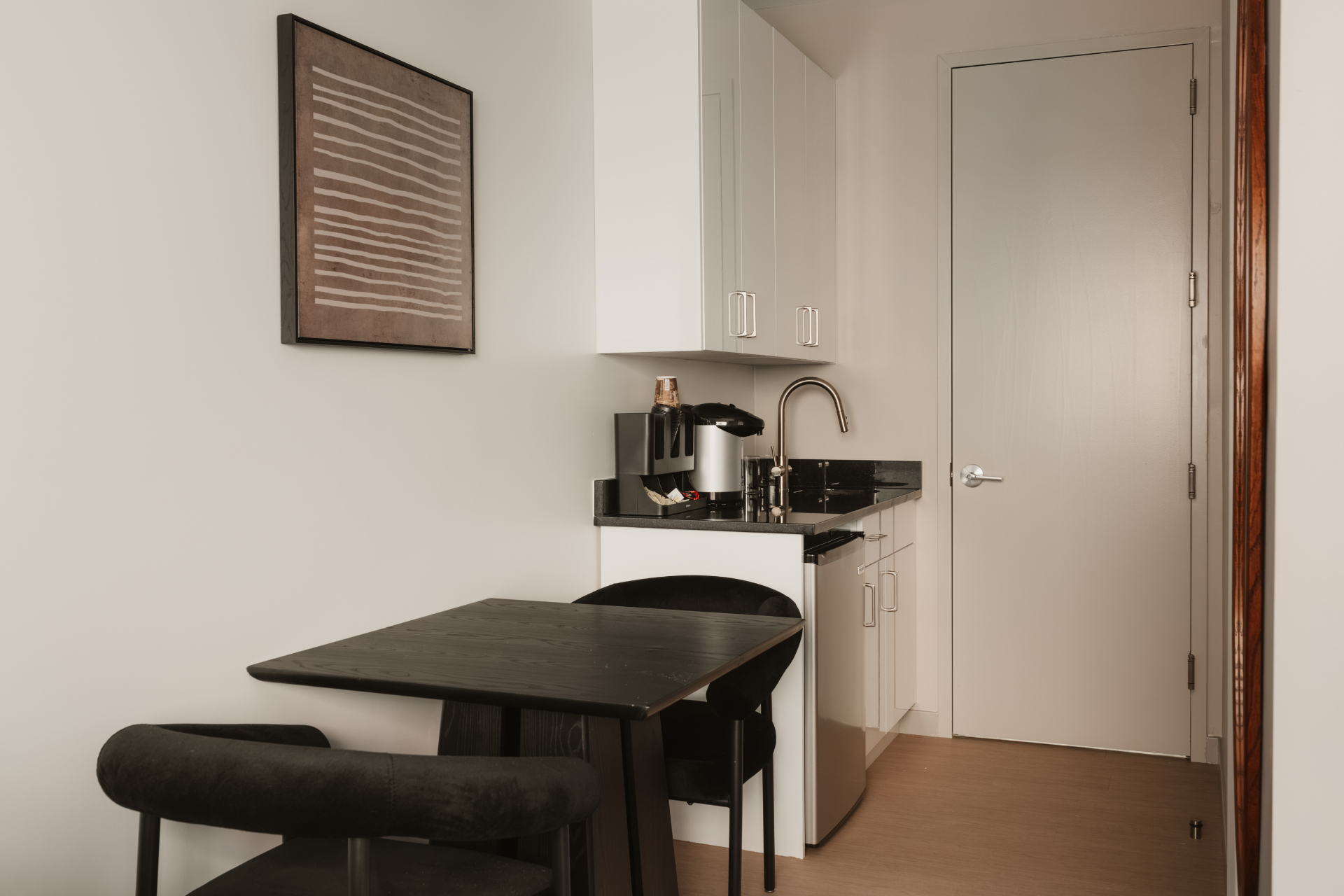 Guest room kitchenette with a small dining table and two chairs
