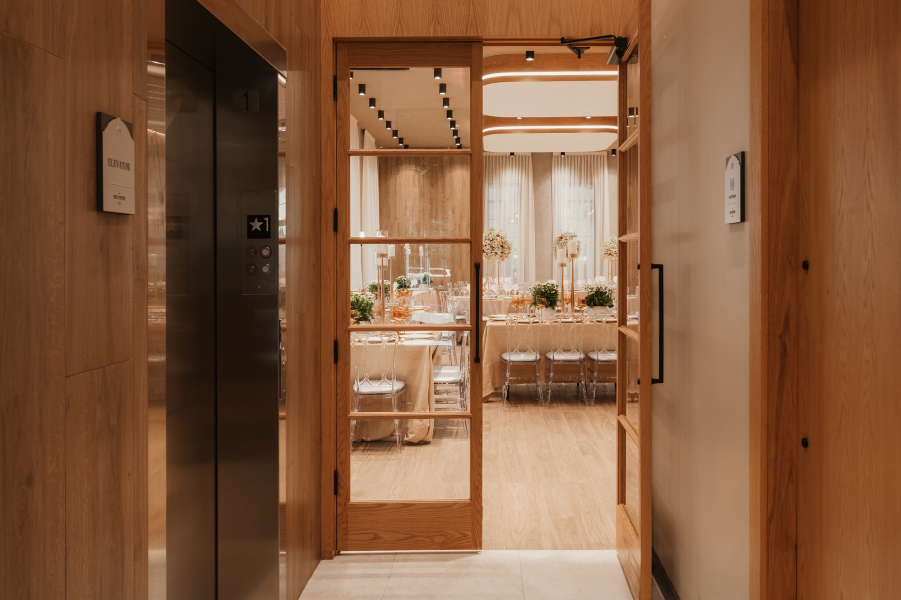Wood-panelled corridor leading to the event room at The Belvedere Suites