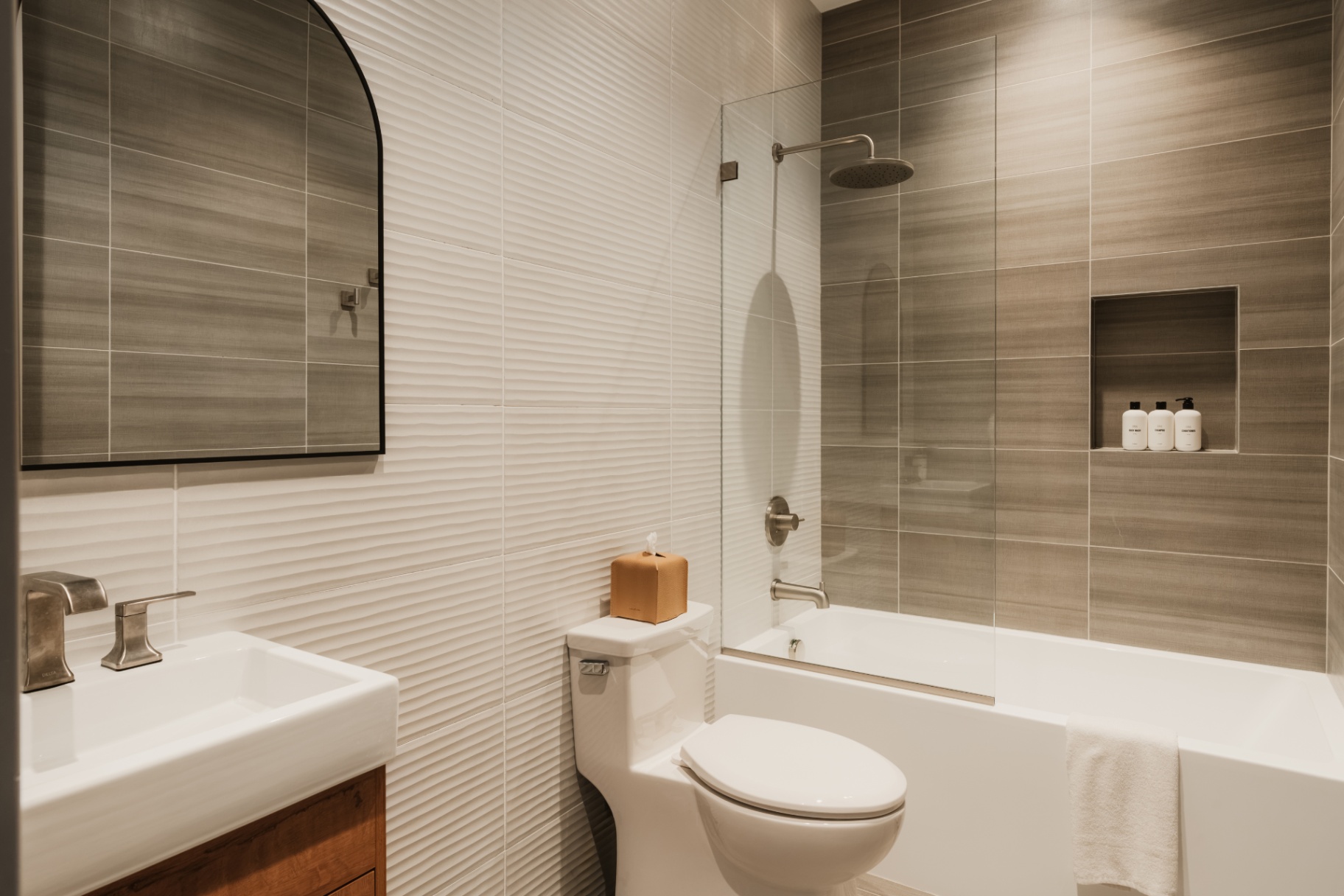 Bathroom with a walk-in shower, tub and wood vanity