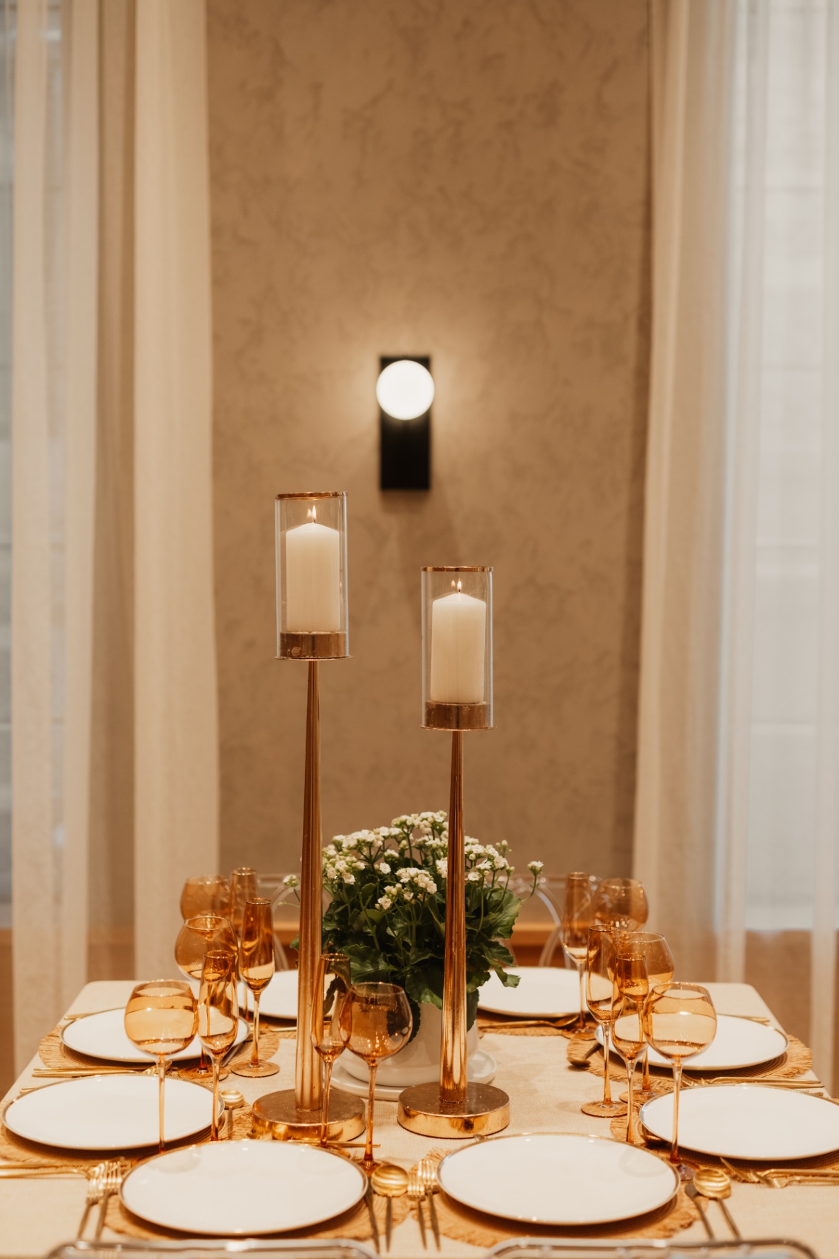 Tablescape with gold candlesticks, amber glassware and white china