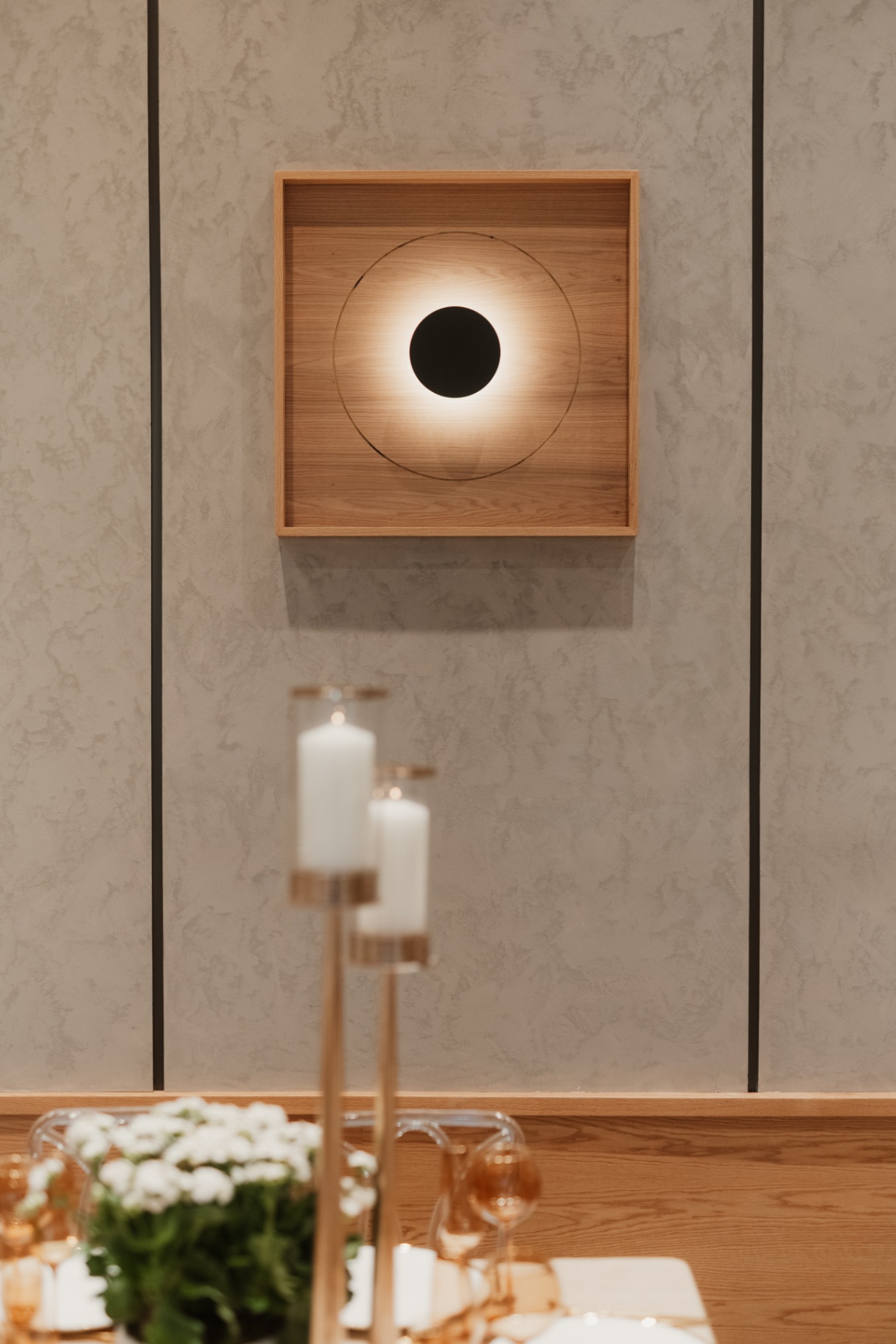 Illuminated wall sconce and candle detail in the event room