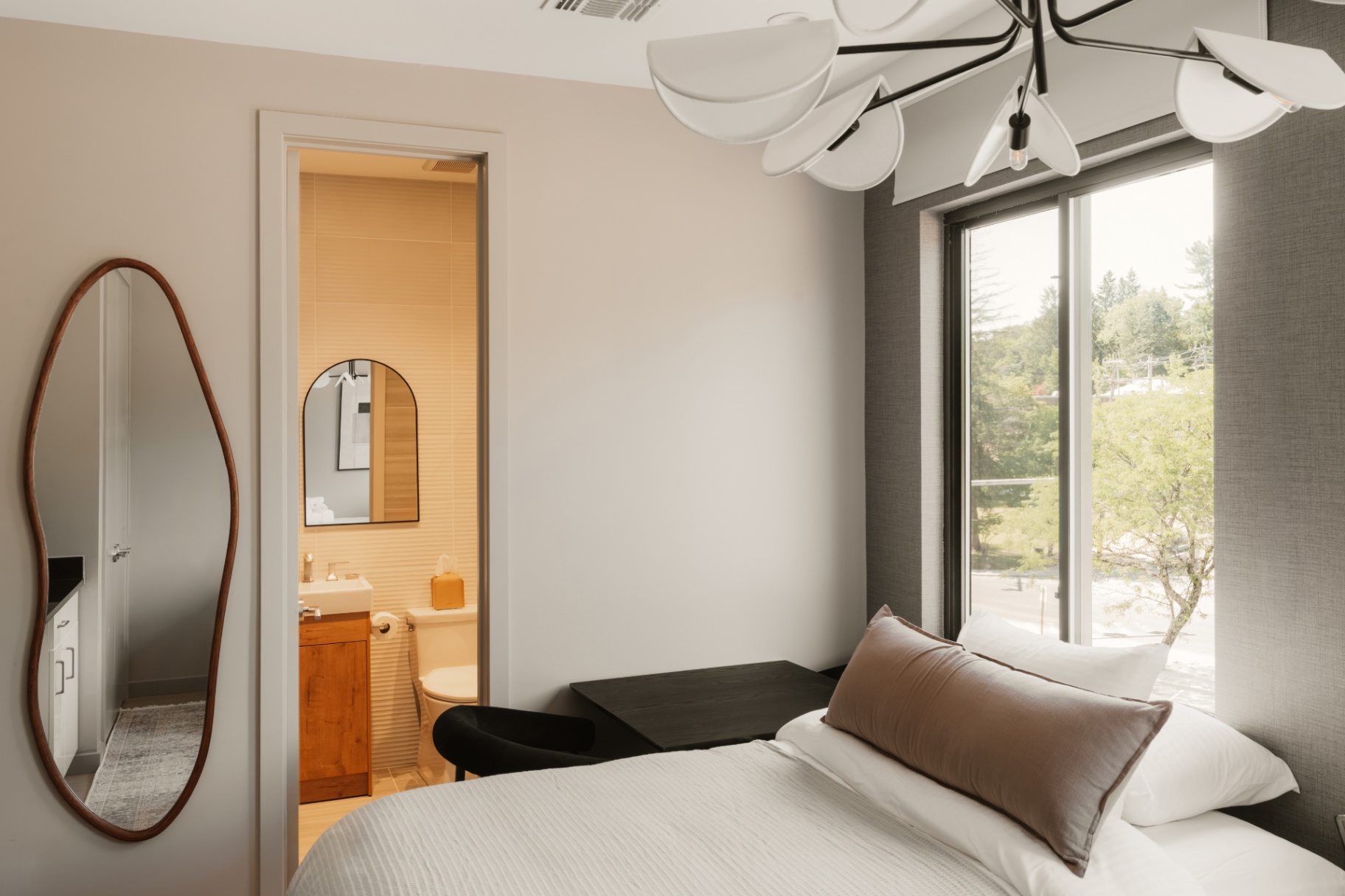 Guest room bed with a view through to the private ensuite bathroom
