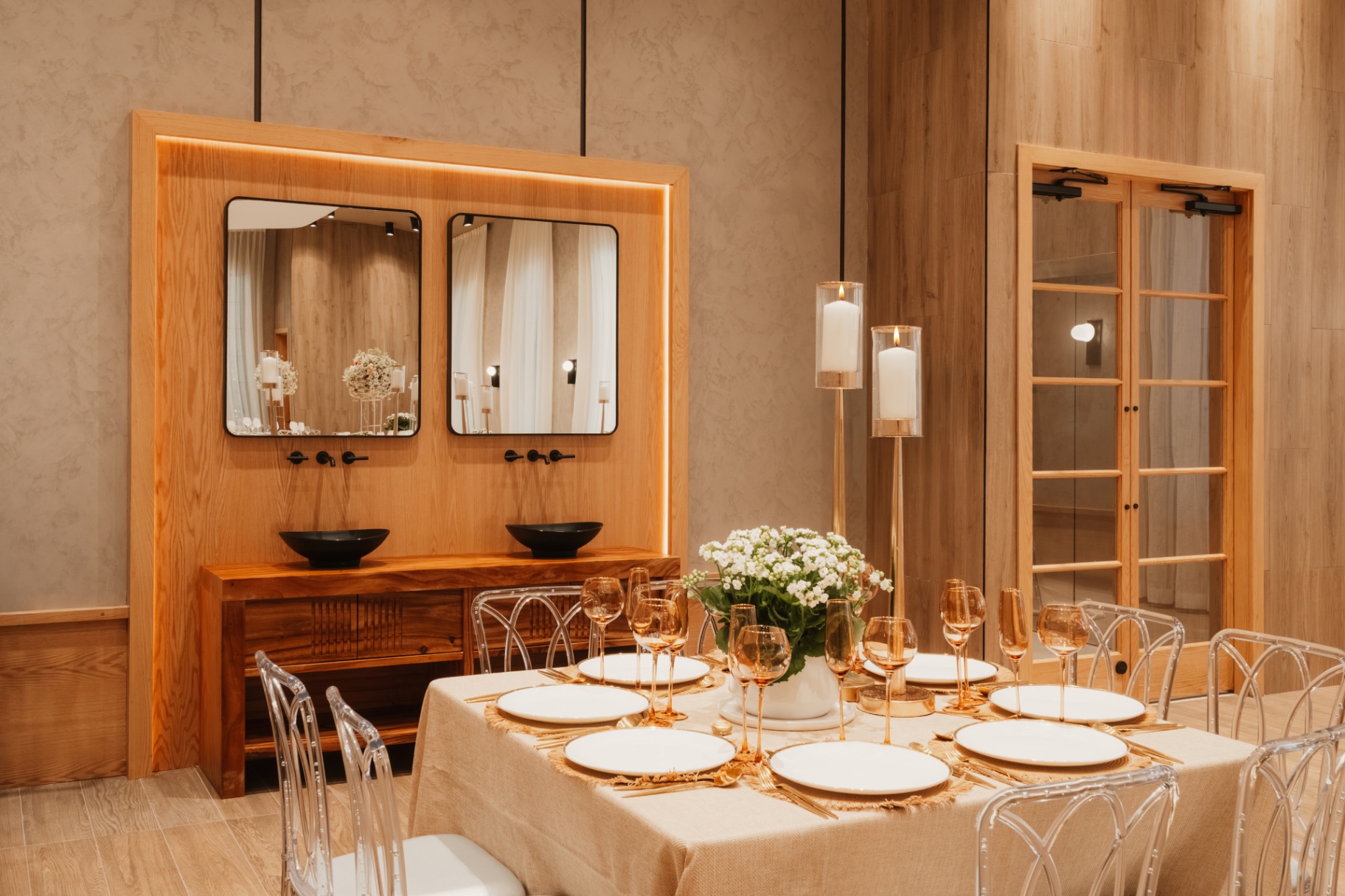 Wooden console with paired mirrors beside a set banquet table