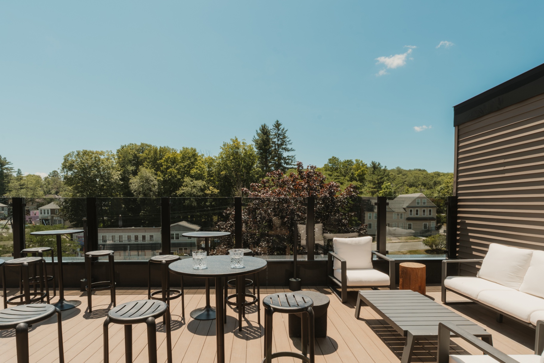 Open-air deck with cafe tables, daybeds and lounge chairs