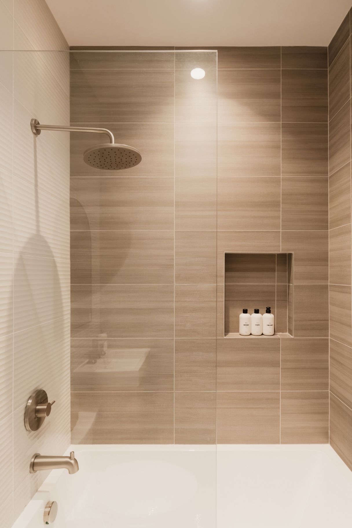 Tiled shower with a rainfall head and built-in toiletry niche