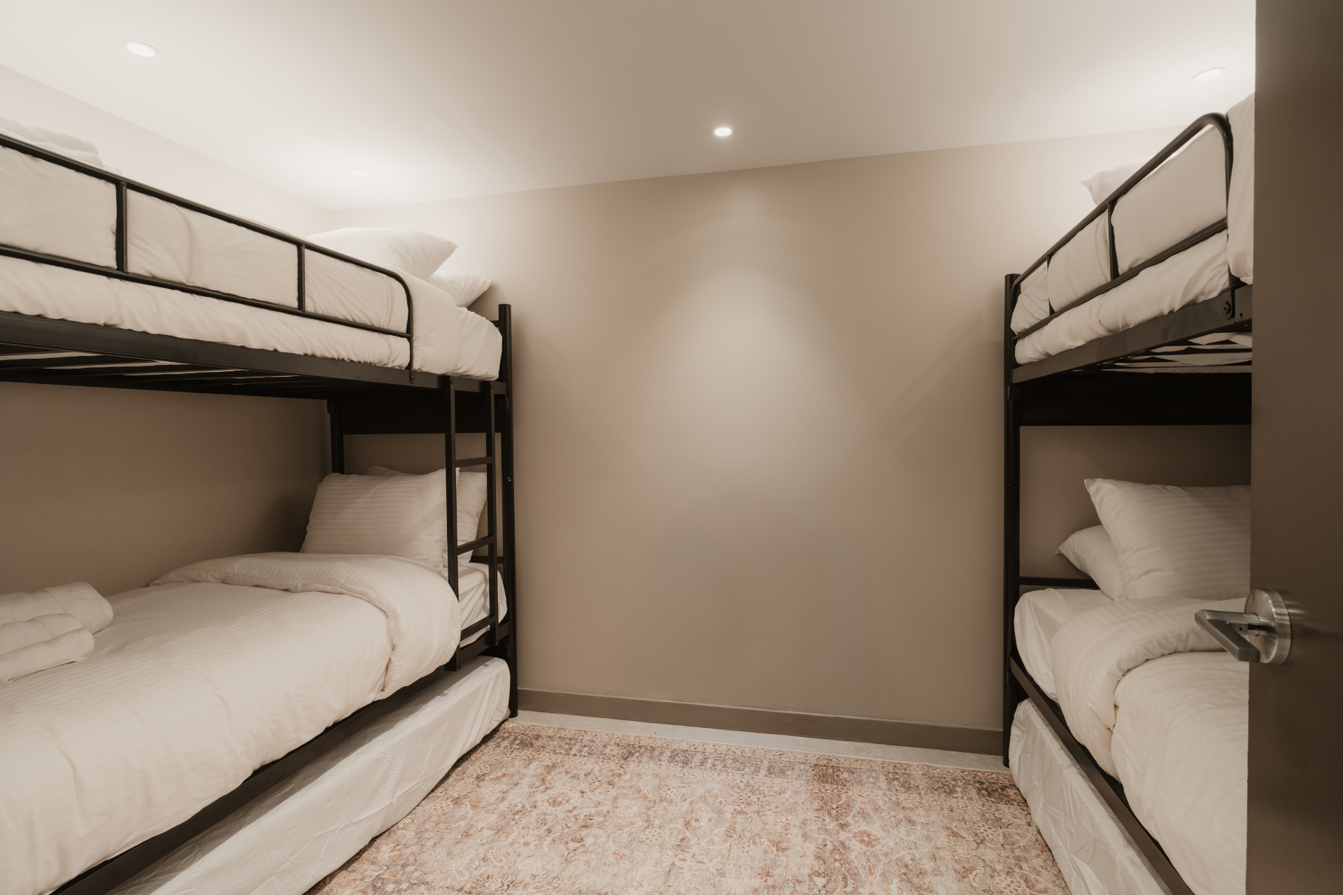 Two sets of bunk beds in a bright family guest room
